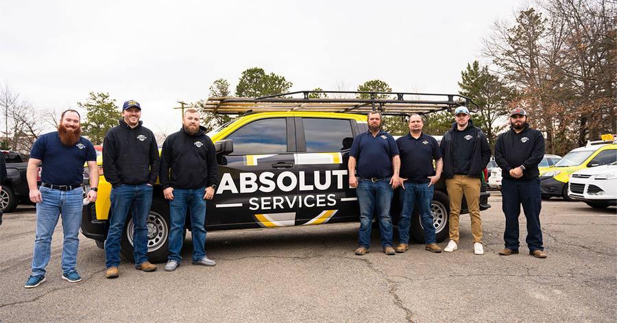 Absolute Services team in front of a branded truck