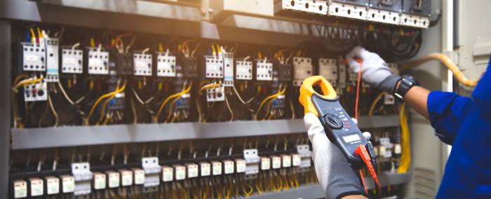 Electrician testing a panel